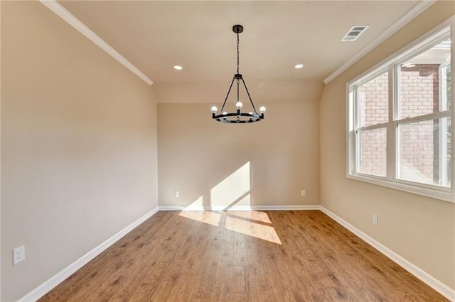 unfurnished dining area featuring crown molding, visible vents, wood finished floors, a chandelier, and baseboards