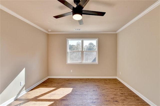 spare room featuring baseboards, visible vents, ceiling fan, and ornamental molding