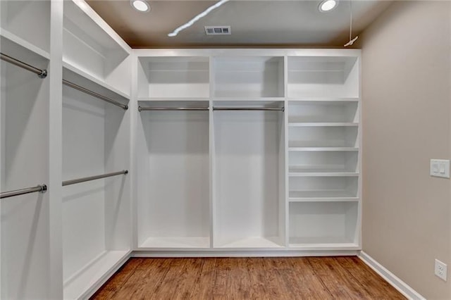 walk in closet with wood finished floors and visible vents