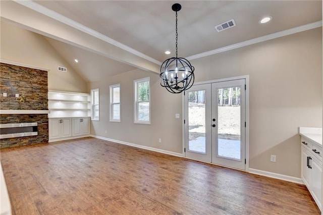 interior space featuring visible vents, baseboards, and wood finished floors