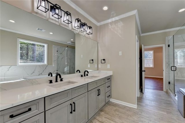 full bath featuring ornamental molding, visible vents, a sink, and double vanity