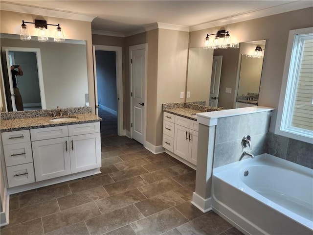 bathroom featuring baseboards, a sink, a garden tub, crown molding, and two vanities