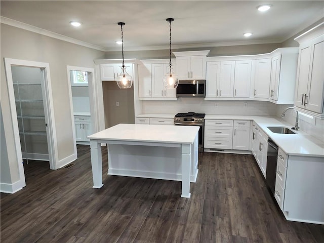 kitchen featuring white cabinetry, stainless steel appliances, a sink, and light countertops