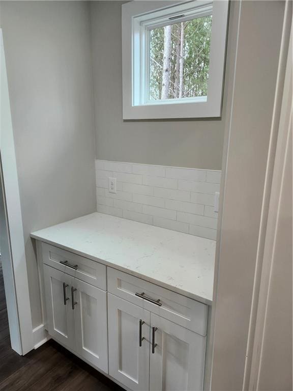 bathroom with tasteful backsplash and wood finished floors