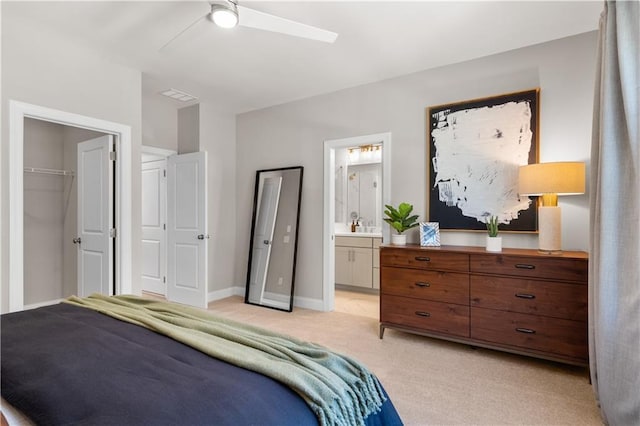 bedroom with light carpet, baseboards, visible vents, a ceiling fan, and ensuite bathroom