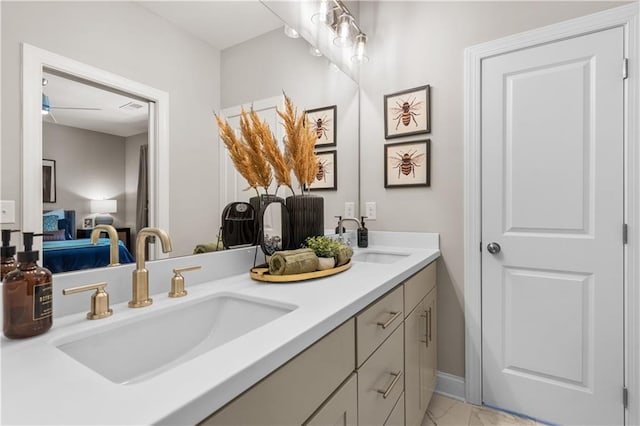 ensuite bathroom with marble finish floor, double vanity, a sink, and connected bathroom