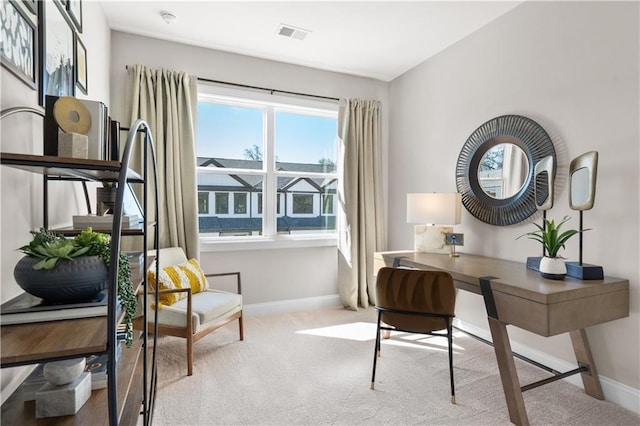 office area featuring light carpet, visible vents, and baseboards