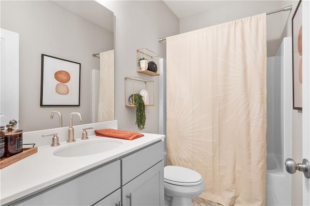 full bath with toilet, shower / bath combo with shower curtain, and vanity