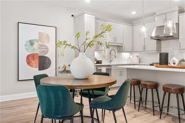 dining space featuring baseboards, recessed lighting, and light wood-style floors