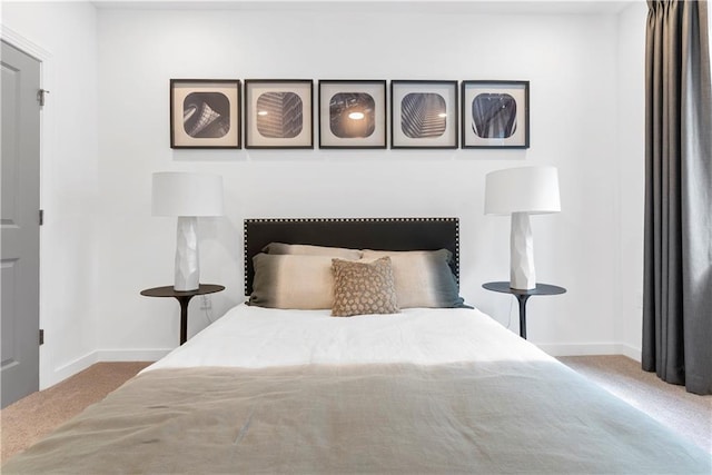 bedroom with baseboards and carpet