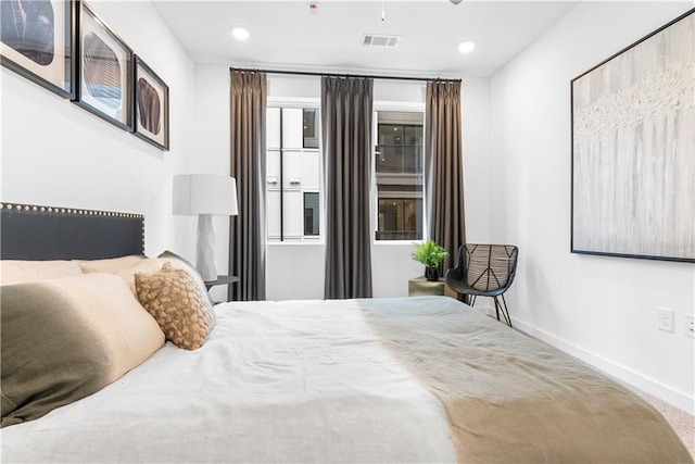 carpeted bedroom featuring baseboards, recessed lighting, and visible vents