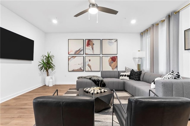 living room with a ceiling fan, baseboards, recessed lighting, and wood finished floors