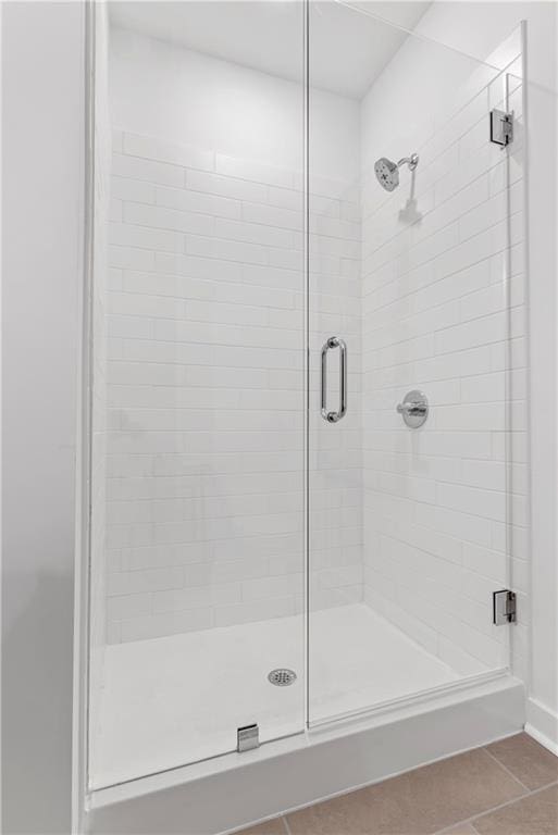 bathroom featuring tile patterned floors and a shower stall
