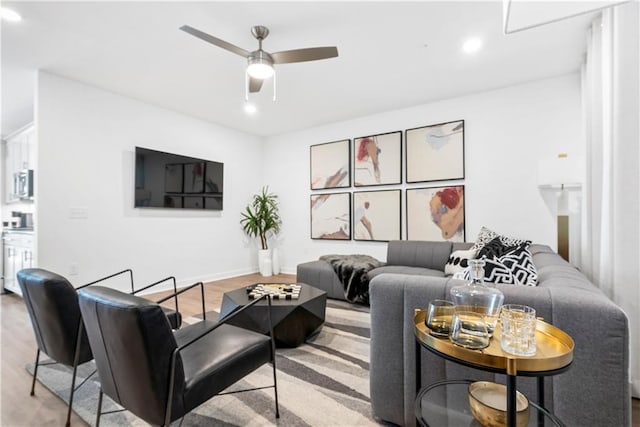 living room with recessed lighting, a ceiling fan, baseboards, and wood finished floors