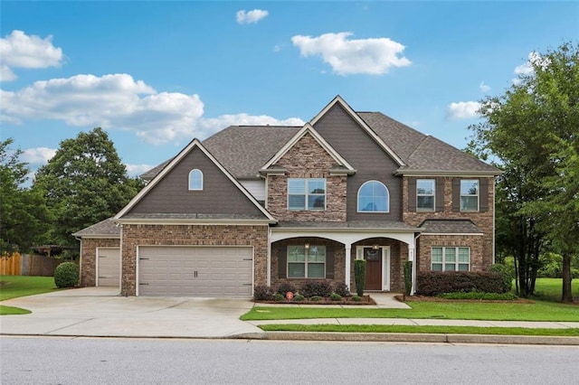 craftsman-style home featuring a garage and a front yard