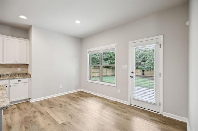 unfurnished dining area with light hardwood / wood-style floors