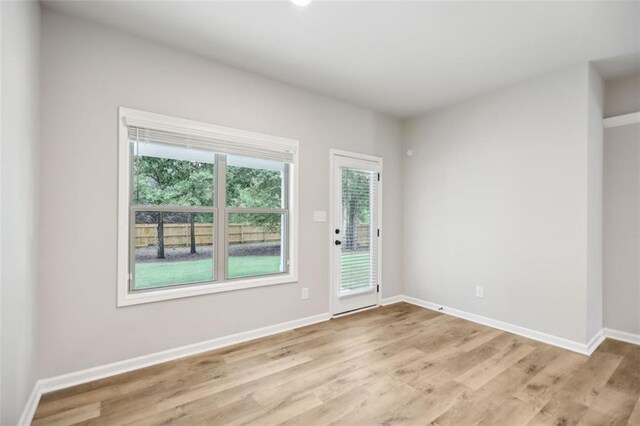 spare room with light hardwood / wood-style floors