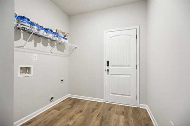 laundry room featuring wood-type flooring, hookup for a washing machine, and electric dryer hookup