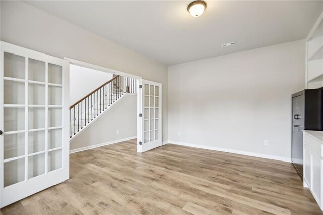 interior space featuring french doors and light hardwood / wood-style floors