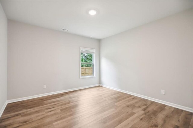 empty room with light hardwood / wood-style floors