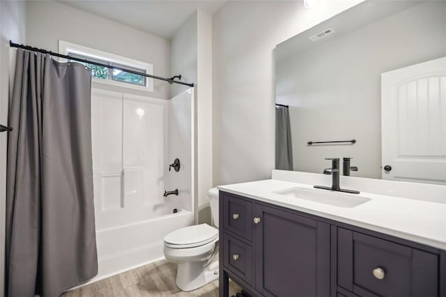 full bathroom featuring shower / tub combo with curtain, vanity, wood-type flooring, and toilet