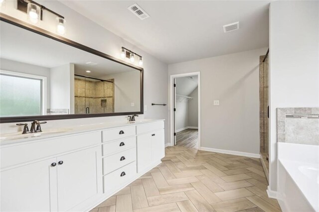 bathroom with vanity, parquet floors, and independent shower and bath