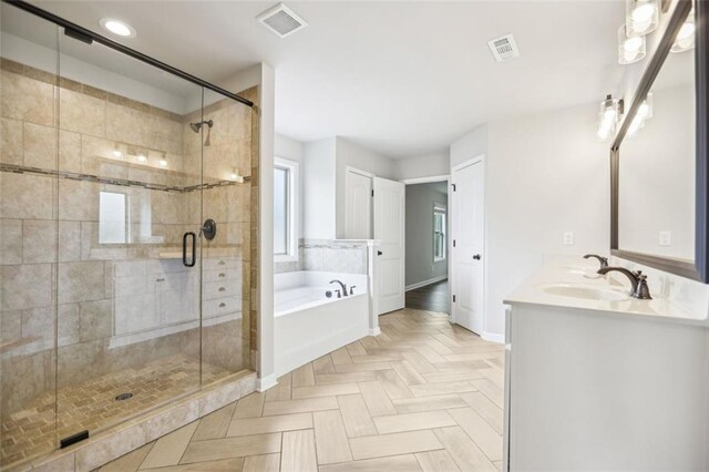 bathroom with vanity and separate shower and tub