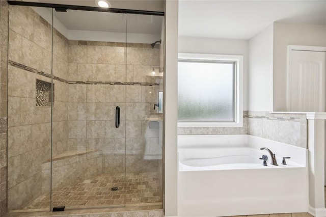 bathroom with shower with separate bathtub