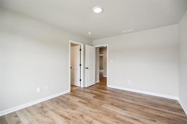 spare room featuring light hardwood / wood-style flooring