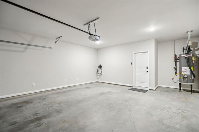 garage featuring water heater and a garage door opener