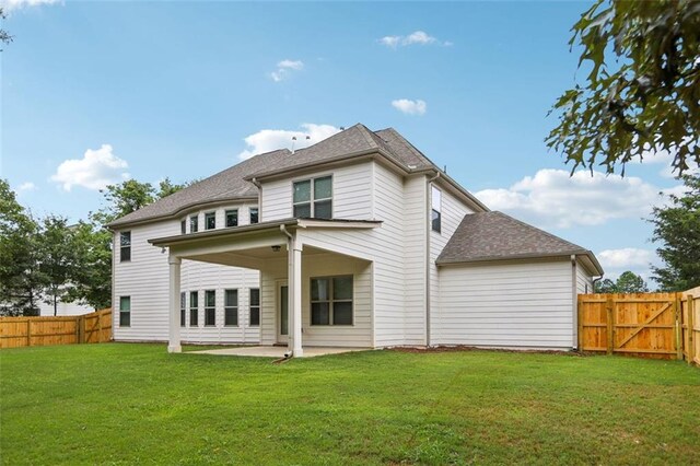 back of house with a yard and a patio area