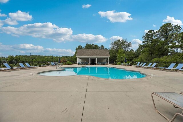 view of pool with a patio area and an outdoor structure