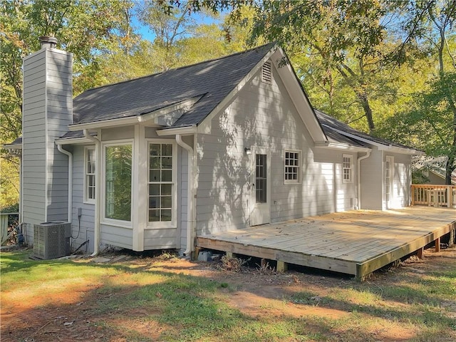 rear view of house with a wooden deck and cooling unit