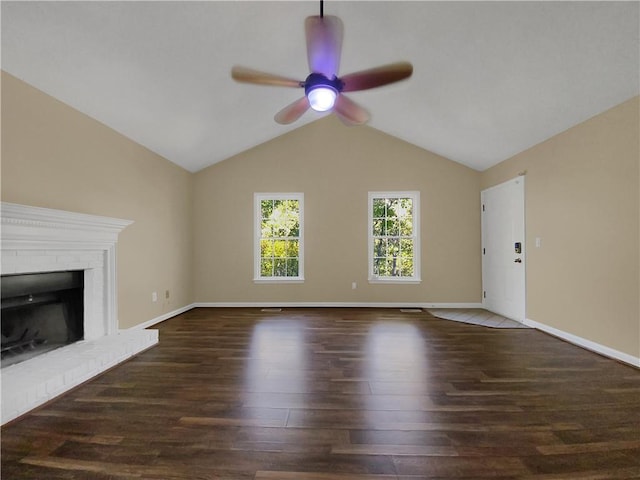 unfurnished living room with lofted ceiling, a fireplace, dark hardwood / wood-style floors, and ceiling fan