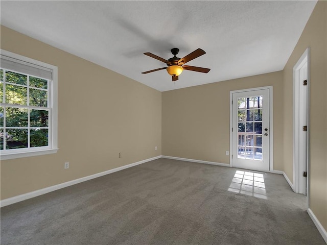 spare room with carpet flooring and ceiling fan