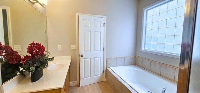 4230 Glen Vista Ct, Duluth, GA 30097 - full bathroom featuring vanity, a bath, and wood finished floors