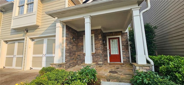 4230 Glen Vista Ct, Duluth, GA 30097 - entrance to property with stone siding, a porch, an attached garage, and driveway