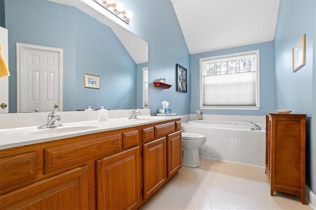 bathroom with toilet, vanity, tiled bath, and vaulted ceiling