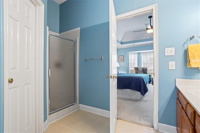 bathroom featuring ceiling fan, vanity, and walk in shower