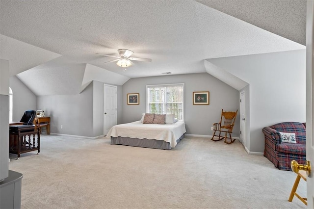 carpeted bedroom with ceiling fan, lofted ceiling, and a textured ceiling