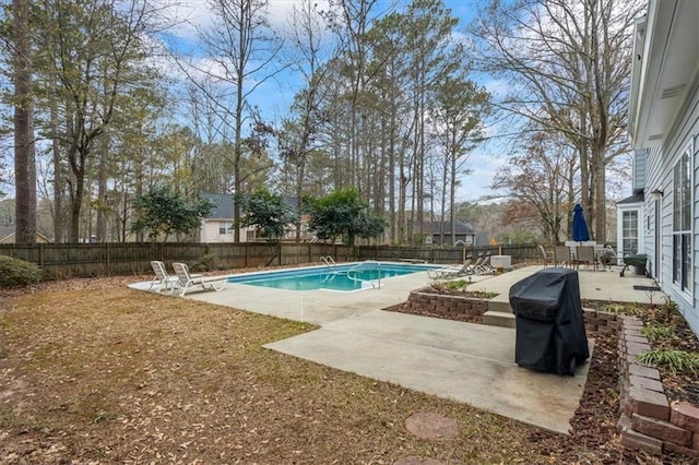 view of swimming pool featuring grilling area and a patio area