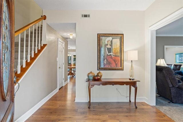 hall featuring crown molding and hardwood / wood-style flooring