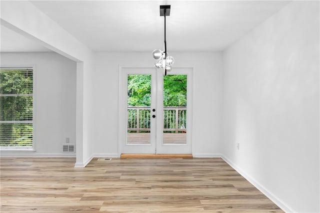 1966 Briarwood Dr, Gainesville, GA 30501 - unfurnished dining area with plenty of natural light, light wood-type flooring, a chandelier, and baseboards