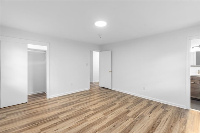 1966 Briarwood Dr, Gainesville, GA 30501 - unfurnished bedroom featuring light wood-style flooring, baseboards, a closet, connected bathroom, and a sink