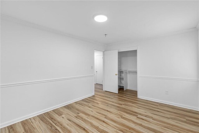 1966 Briarwood Dr, Gainesville, GA 30501 - unfurnished bedroom with ornamental molding, light wood-type flooring, a closet, and baseboards