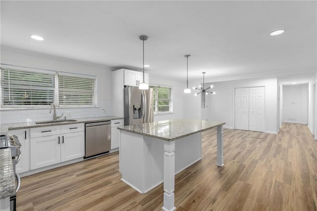 1966 Briarwood Dr, Gainesville, GA 30501 - kitchen with appliances with stainless steel finishes, a sink, white cabinetry, crown molding, and tasteful backsplash