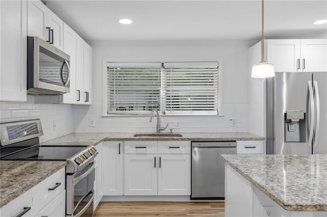 1966 Briarwood Dr, Gainesville, GA 30501 - kitchen with stainless steel appliances, a sink, white cabinetry, tasteful backsplash, and light stone counters