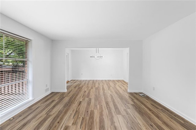 1966 Briarwood Dr, Gainesville, GA 30501 - unfurnished room with wood finished floors, baseboards, and a chandelier