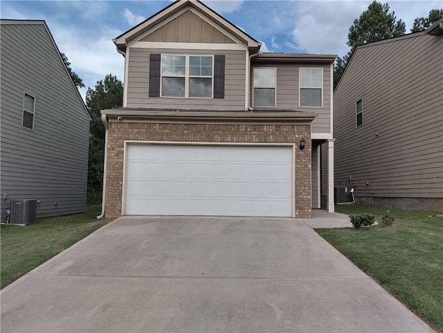 view of front of house with cooling unit, a garage, and a front yard