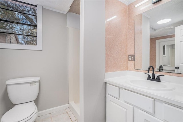 bathroom with a stall shower, baseboards, toilet, tile patterned floors, and vanity